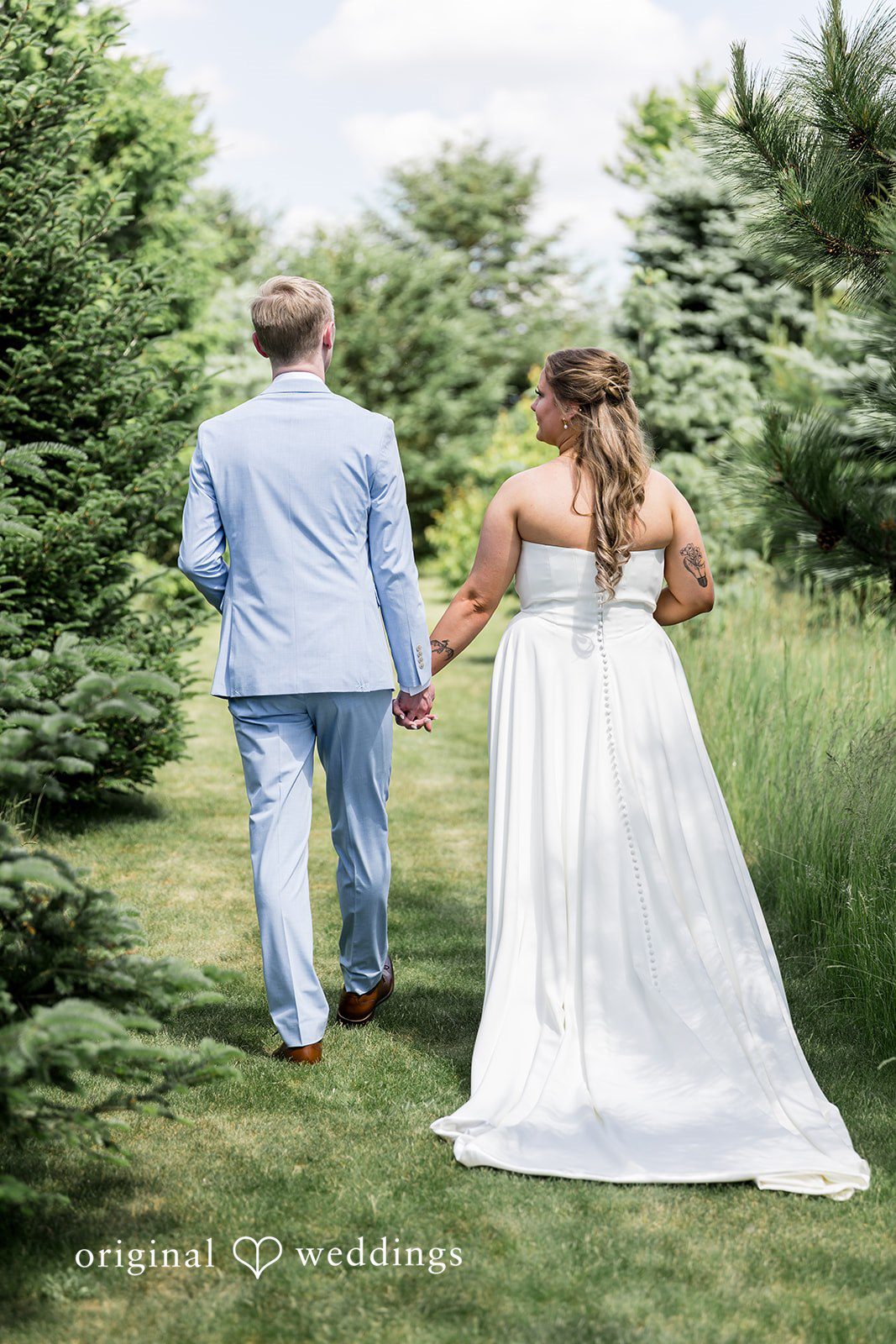 Emily + Ridge Couple holding hands and walking together at Spruce Hill