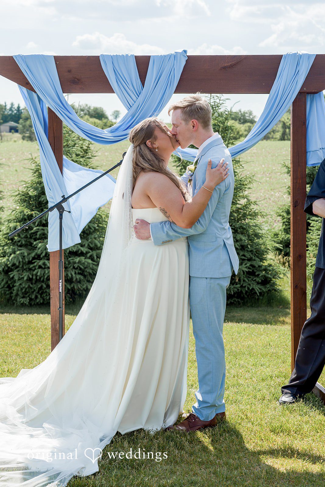 Emily + Ridge Newlyweds celebrating their first kiss at Spruce Hill