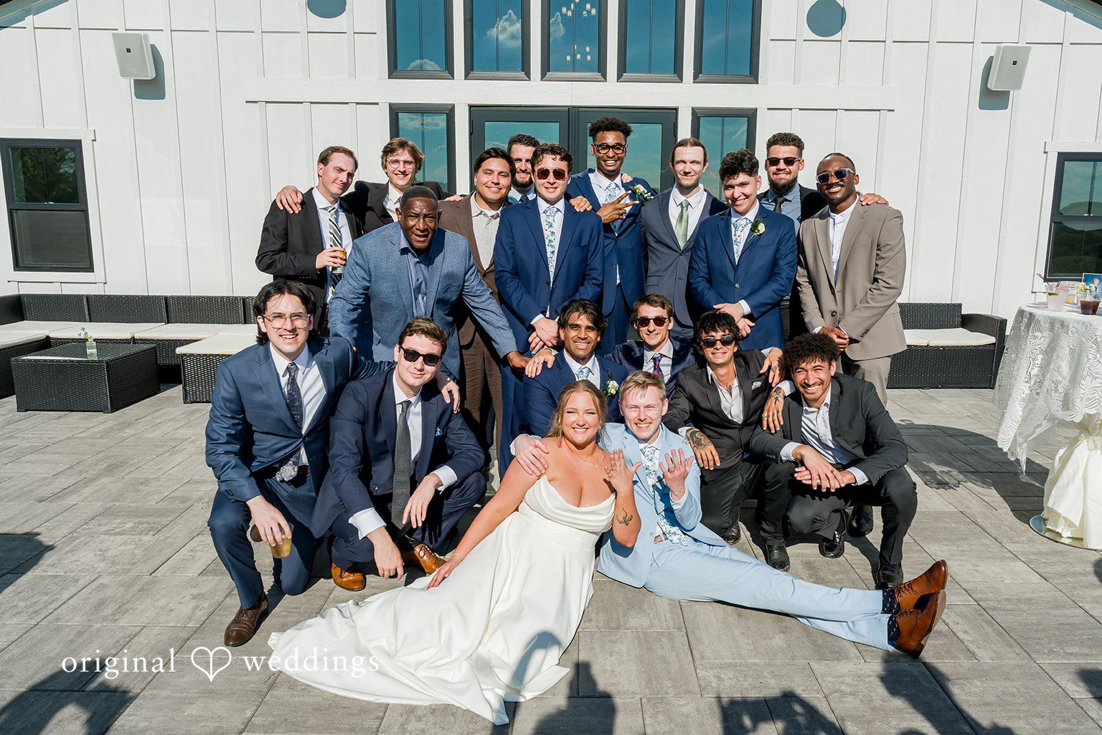 Emily + Ridge Groom celebrating with friends at Spruce Hill captured by Minneapolis Wedding Photographers from Original Weddings.