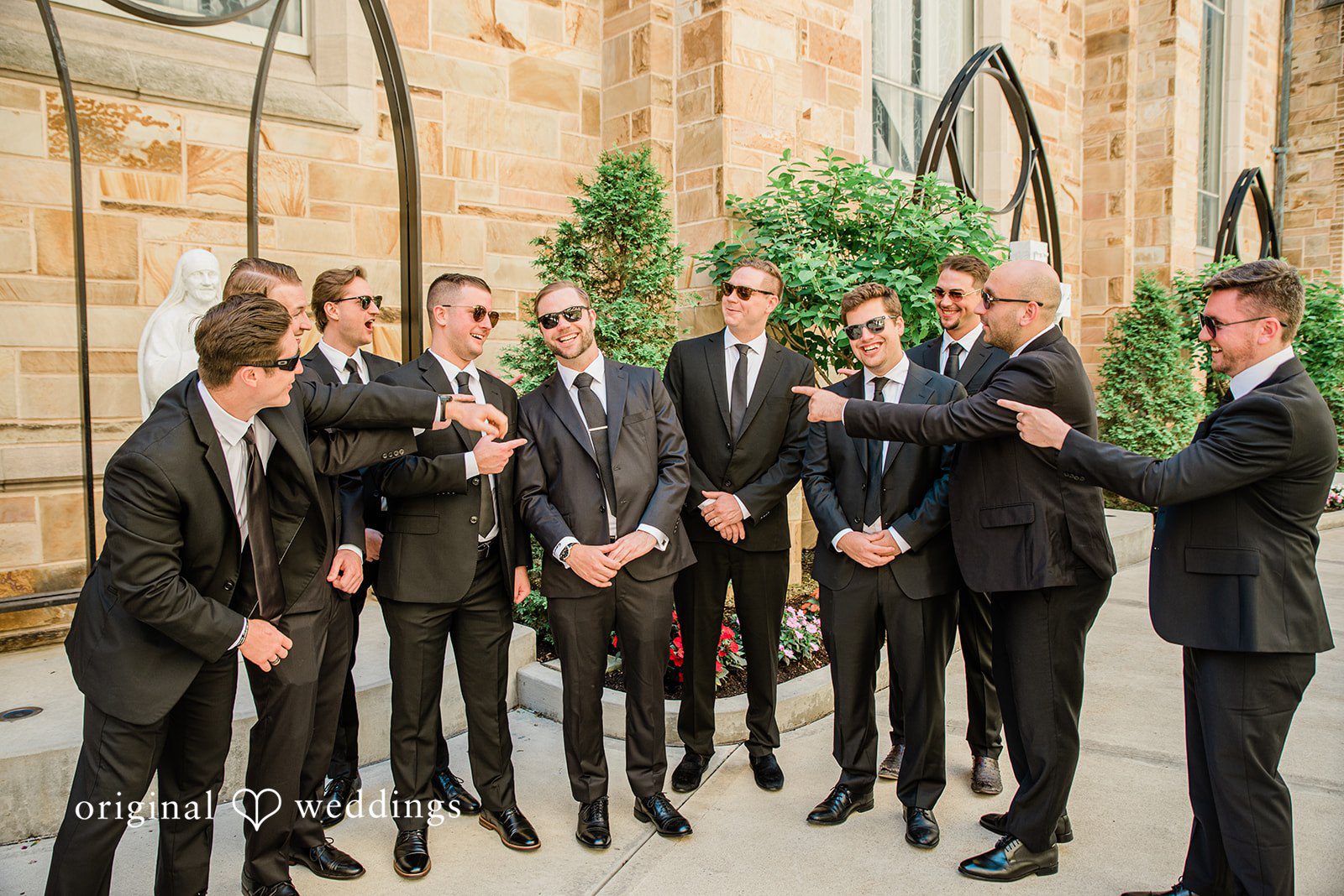 Luke + Madison Groom and his groomsmen posing together before the ceremony at St. Clair Ballroom.