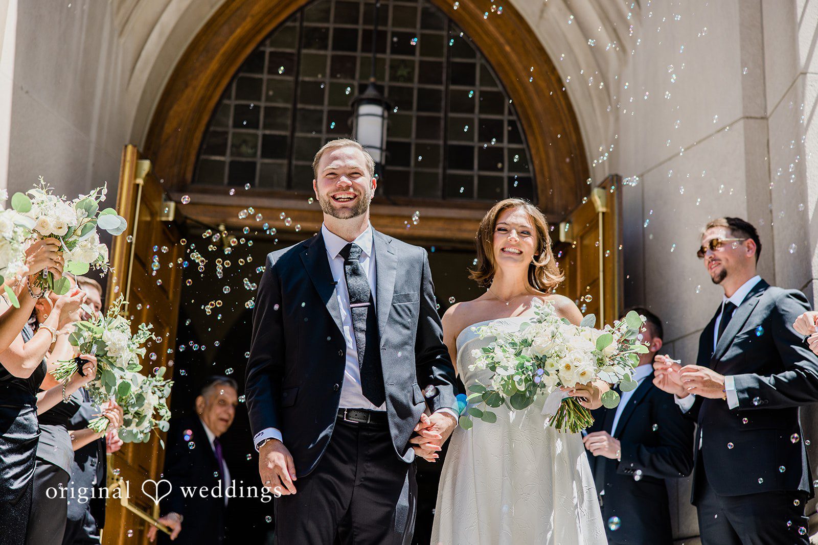 Luke + Madison Couple walking outside after the ceremony at St. Clair Ballroom captured by Cleveland Wedding Photographers from Original Weddings.
