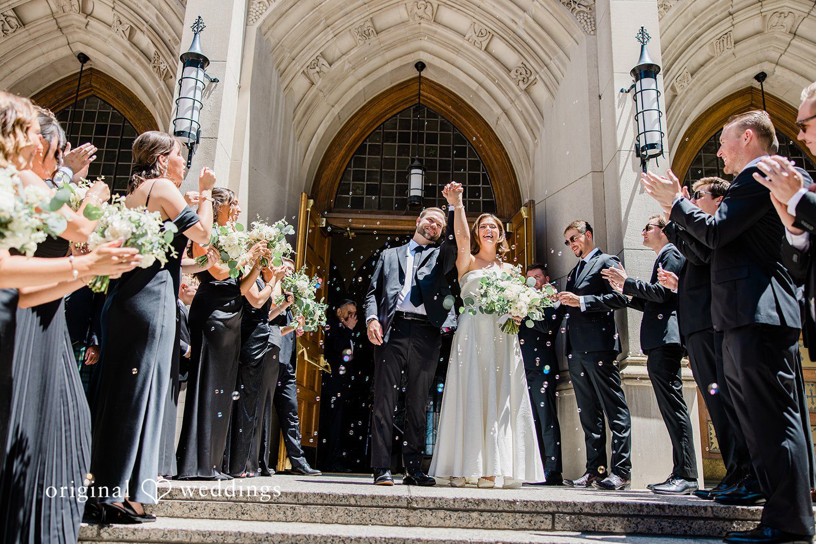 Luke + Madison Newlyweds smiling together outside St. Clair Ballroom after the ceremony.