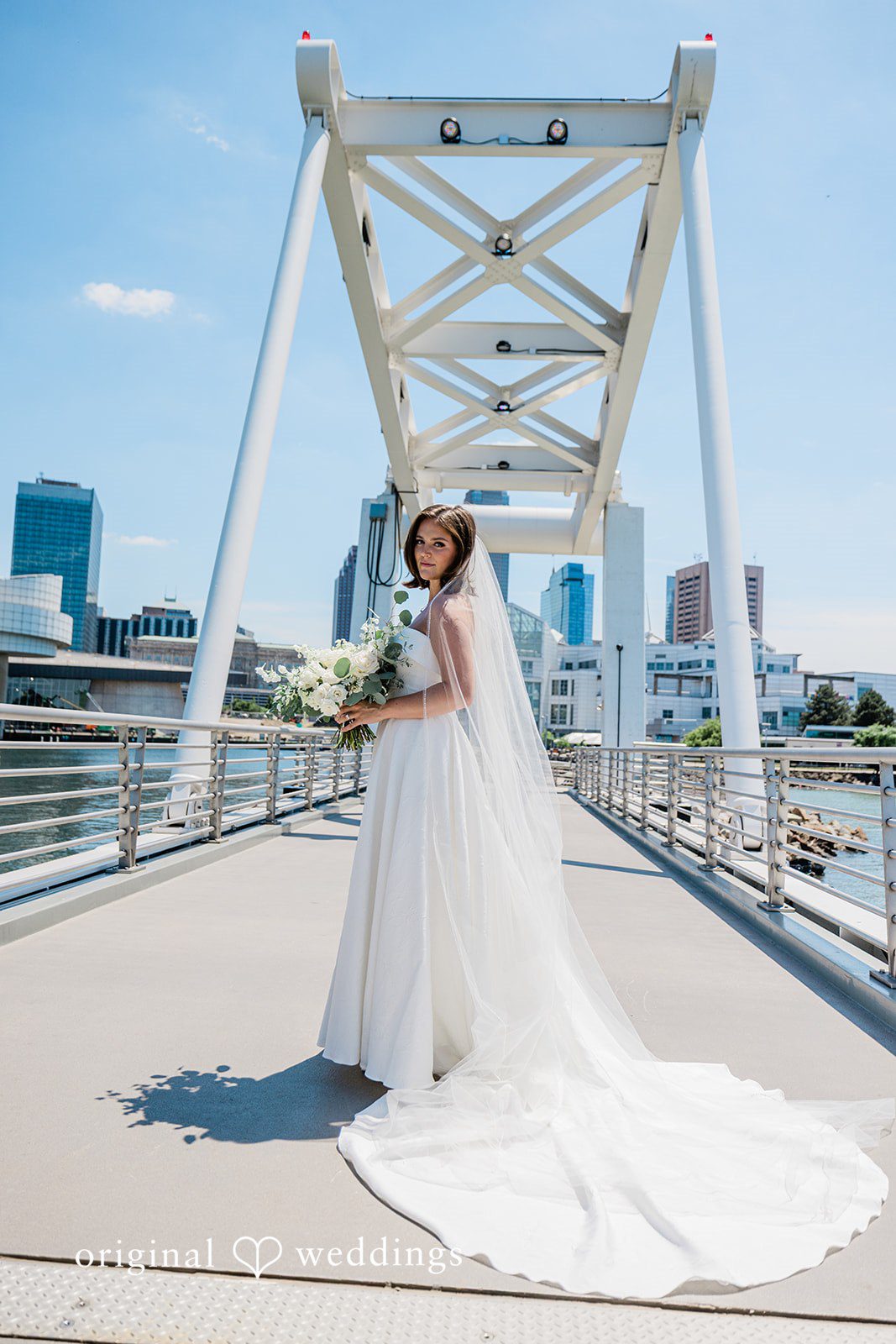Luke + Madison Bride Smiling While Holding a Bouquet at St. Clair Ballroom