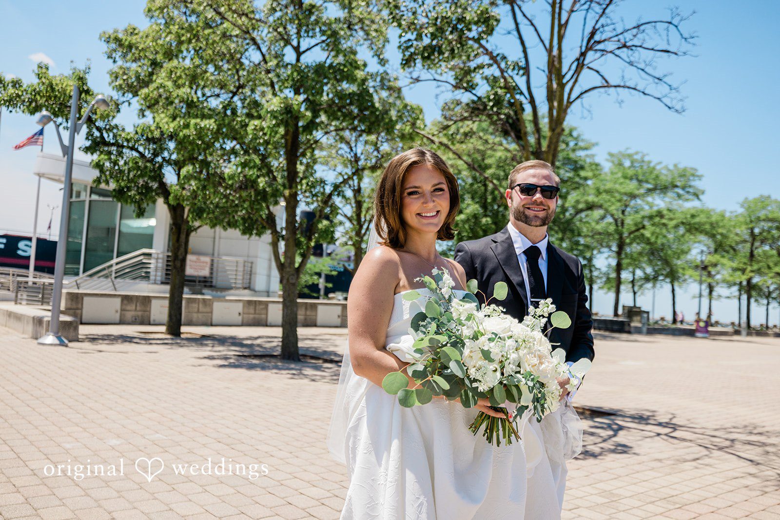 Luke + Madison Happy newlyweds holding a bouquet during outdoor portraits at St. Clair Ballroom.