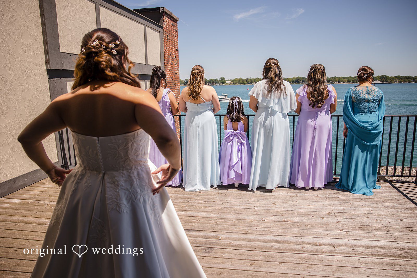 James + Nora Bride standing behind her bridesmaids during a wedding portrait at St. Clair Inn