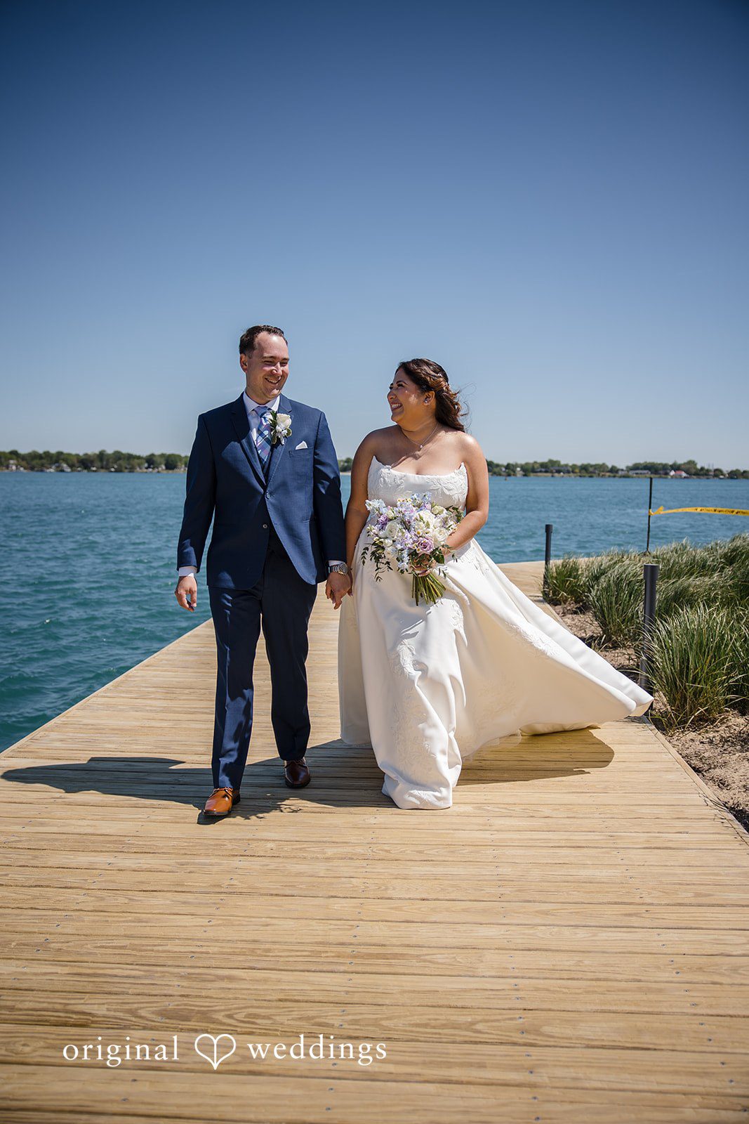 James + Nora Bride and groom walking together after the ceremony at St. Clair Inn