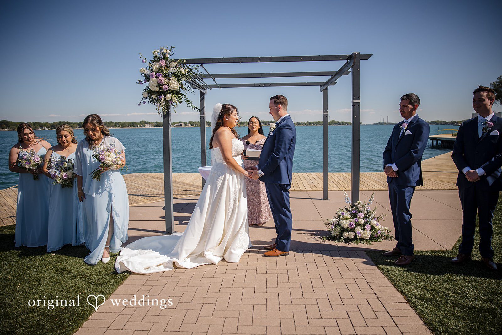 James + Nora Detroit Wedding Photographers capturing couple standing before the priest at St. Clair Inn by Original Weddings
