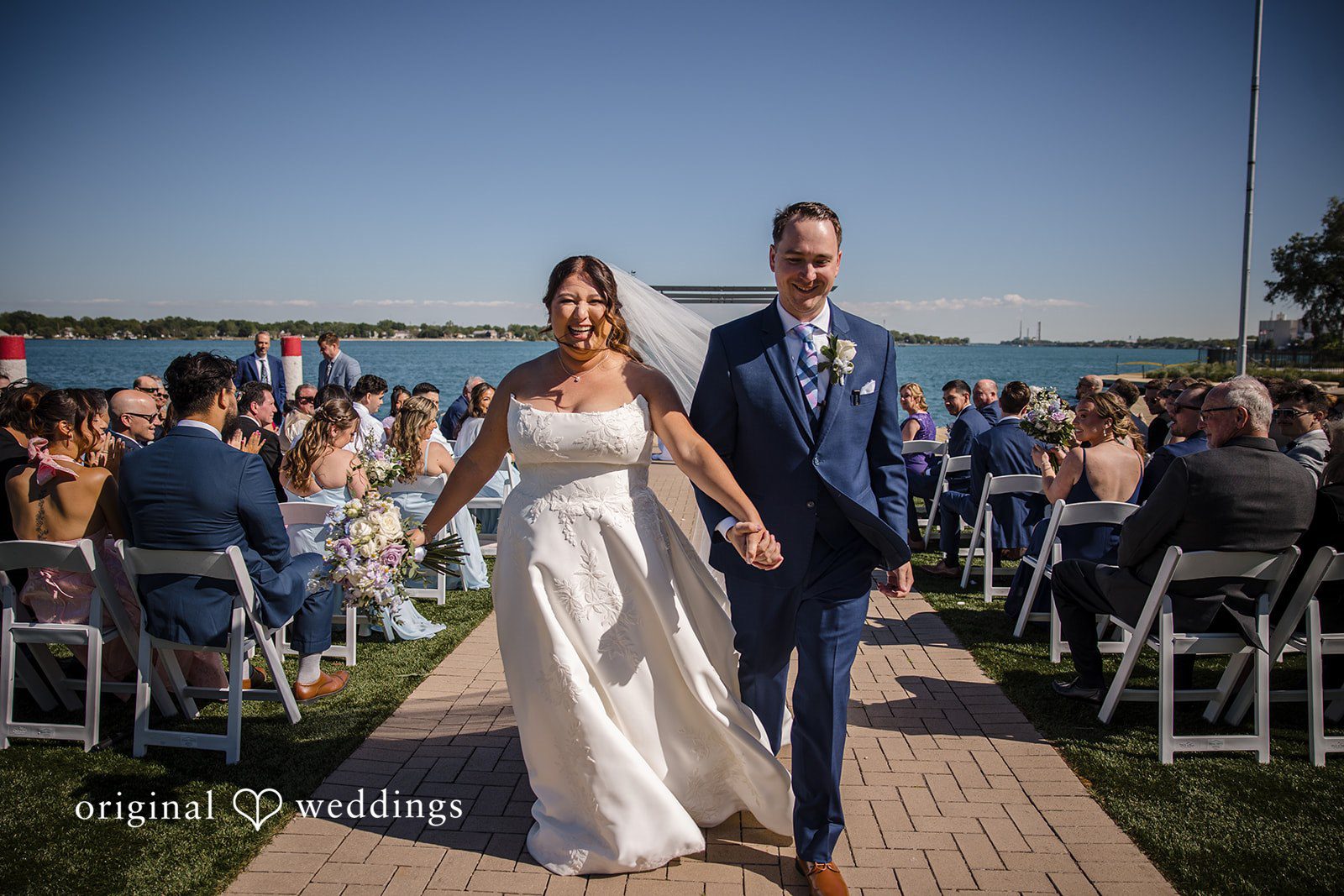 James + Nora Happy couple exiting the ceremony at St. Clair Inn