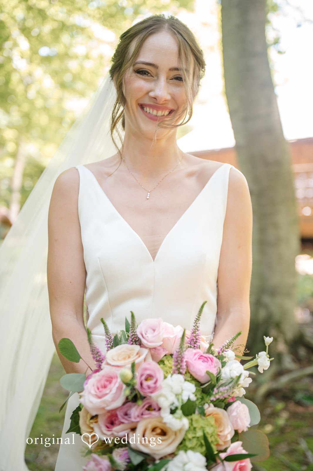 Laura + Robert A beautiful portrait of the bride carrying her huge bouquet