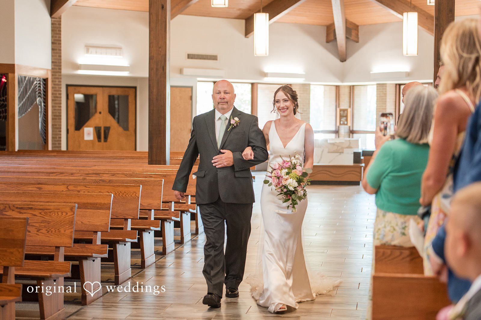 Laura + Robert The bride's father escorts the bride down the aisle