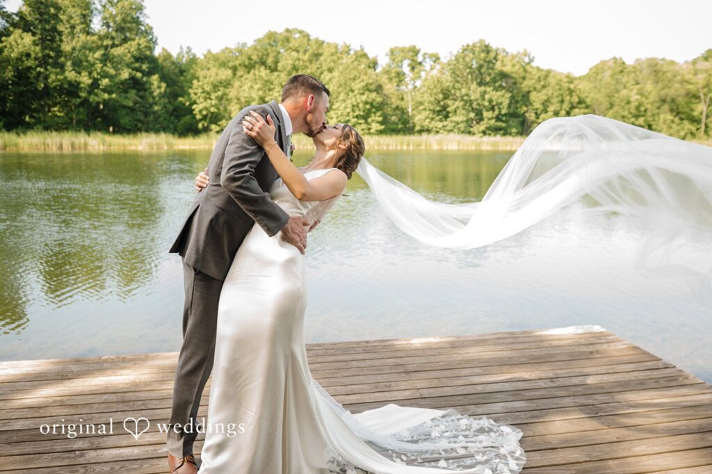Laura + Robert The couple shares a romantic kiss by the water side