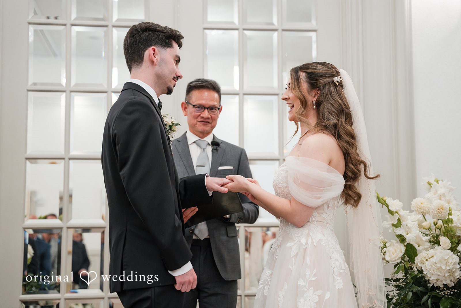 Bride placing a wedding ring on the groom during their Sterling Hotel ceremony captured by Sacramento Wedding Photographers at Sterling Hotel