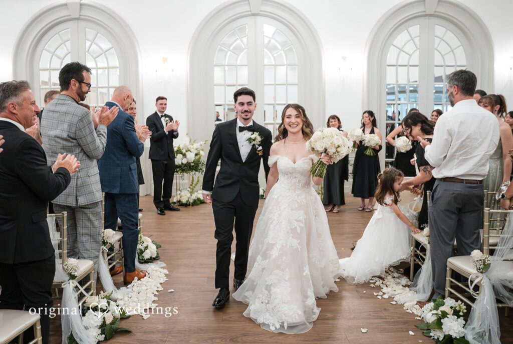 Bride and groom walking down the aisle after their Sterling Hotel wedding ceremony  captured by Sacramento Wedding Photographers at Sterling Hotel