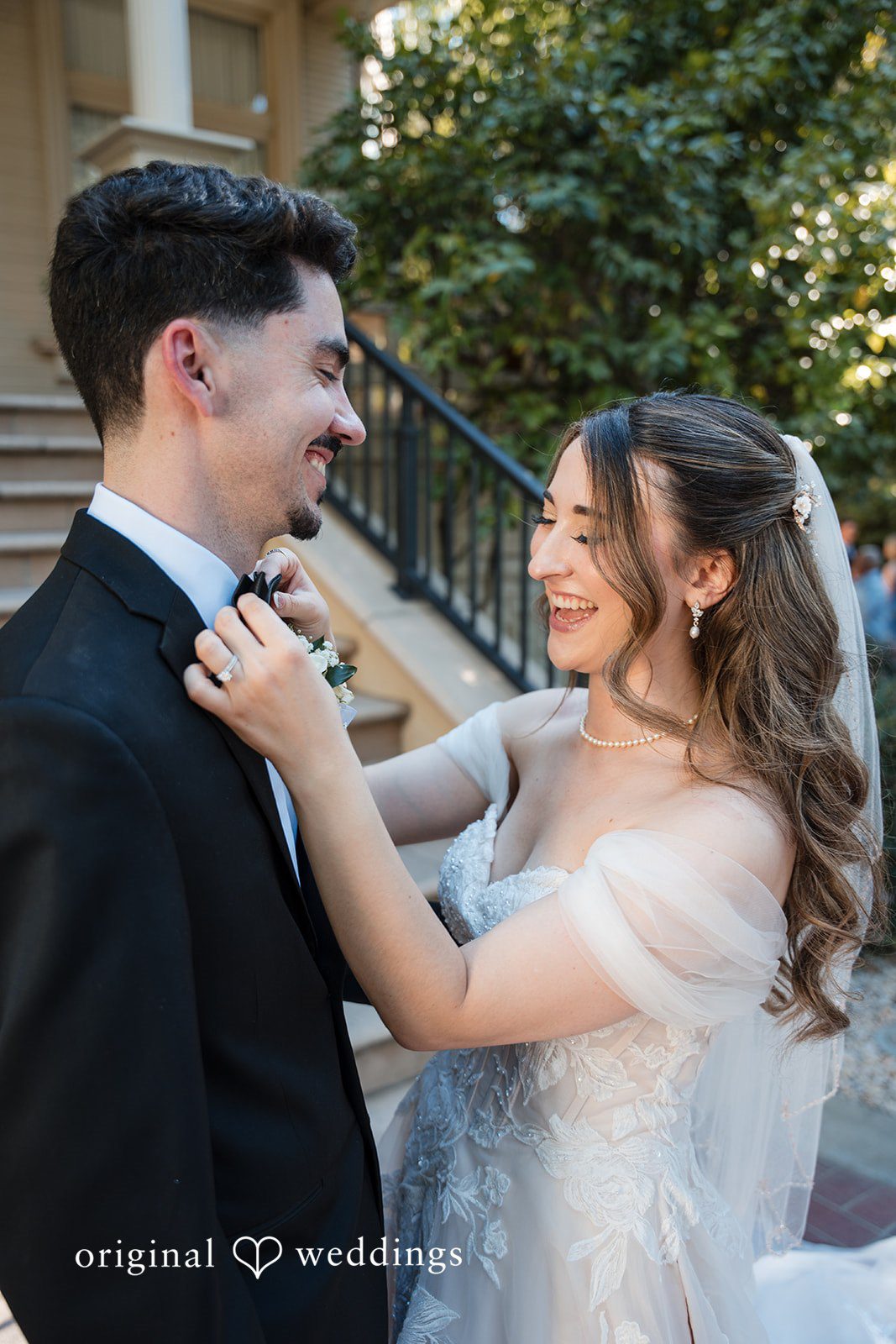 Bride adjusting the groom's bow tie