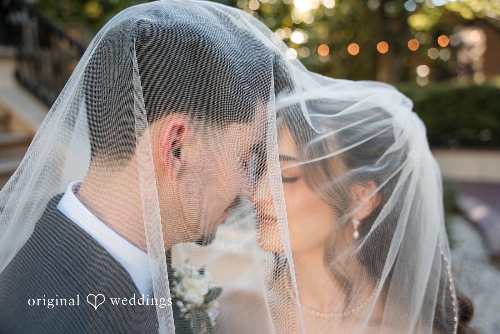 Newlyweds sharing a beautiful moment beneath the bridal veil