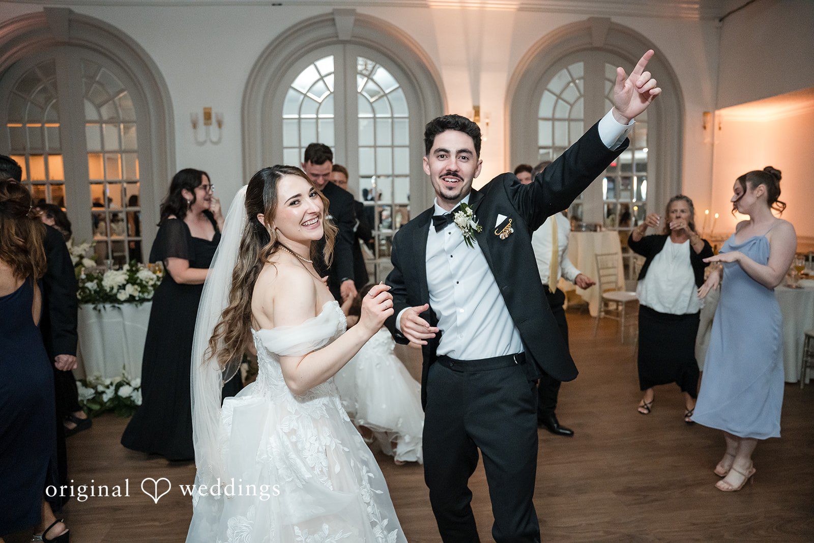 Bride and groom dancing with guests at Sterling Hotel captured by Sacramento Wedding Photographers from Original Weddings