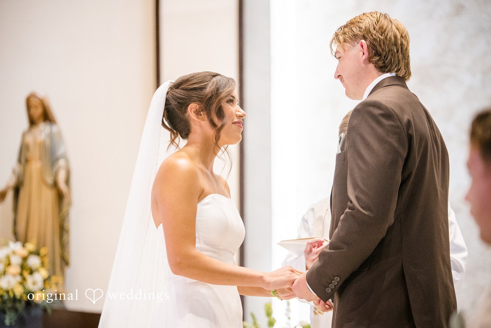 Couple looking at each other with smiles at  San Pedro Catholic Church