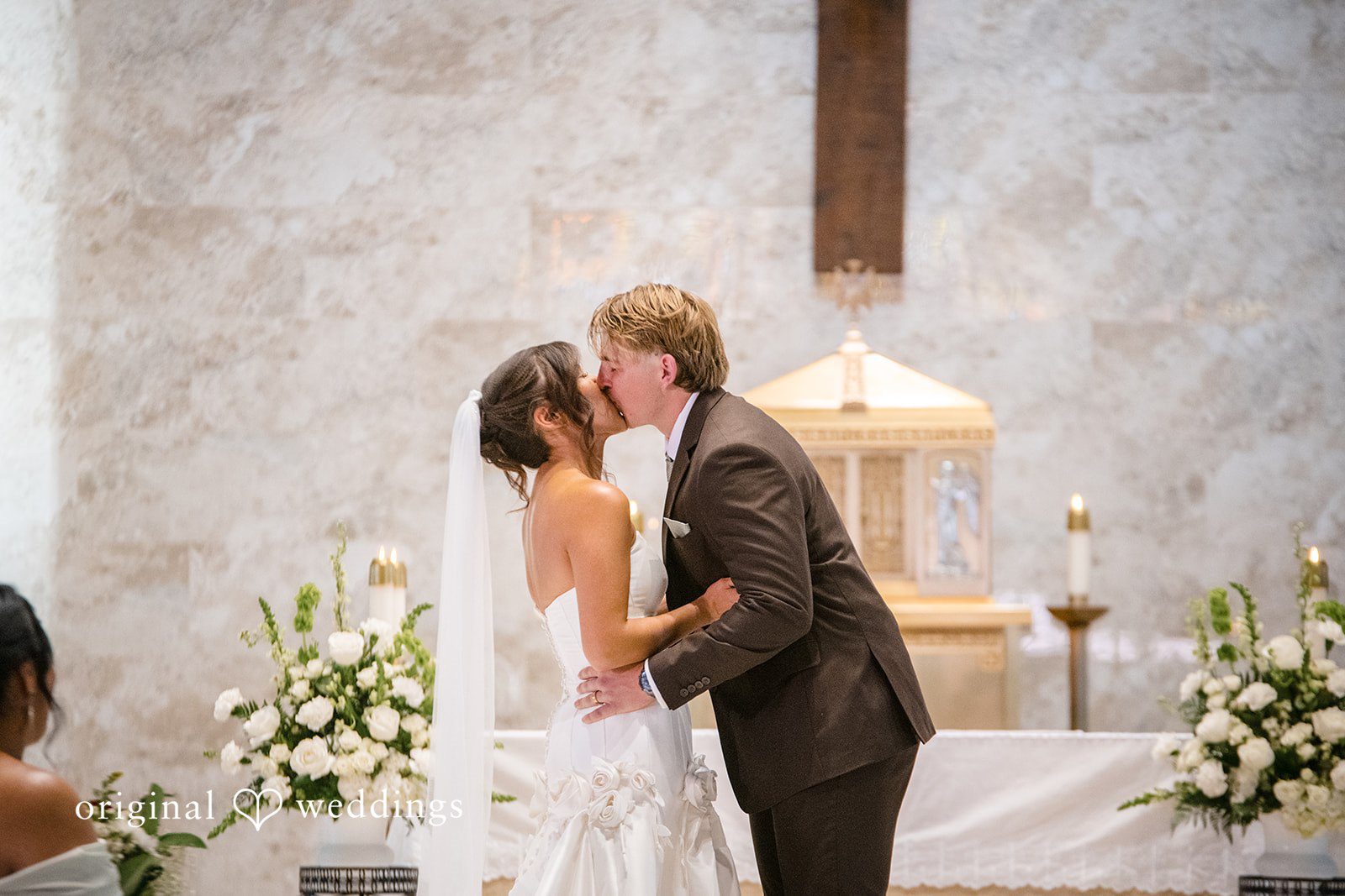Couple sharing a romantic kiss at San Pedro Catholic Church