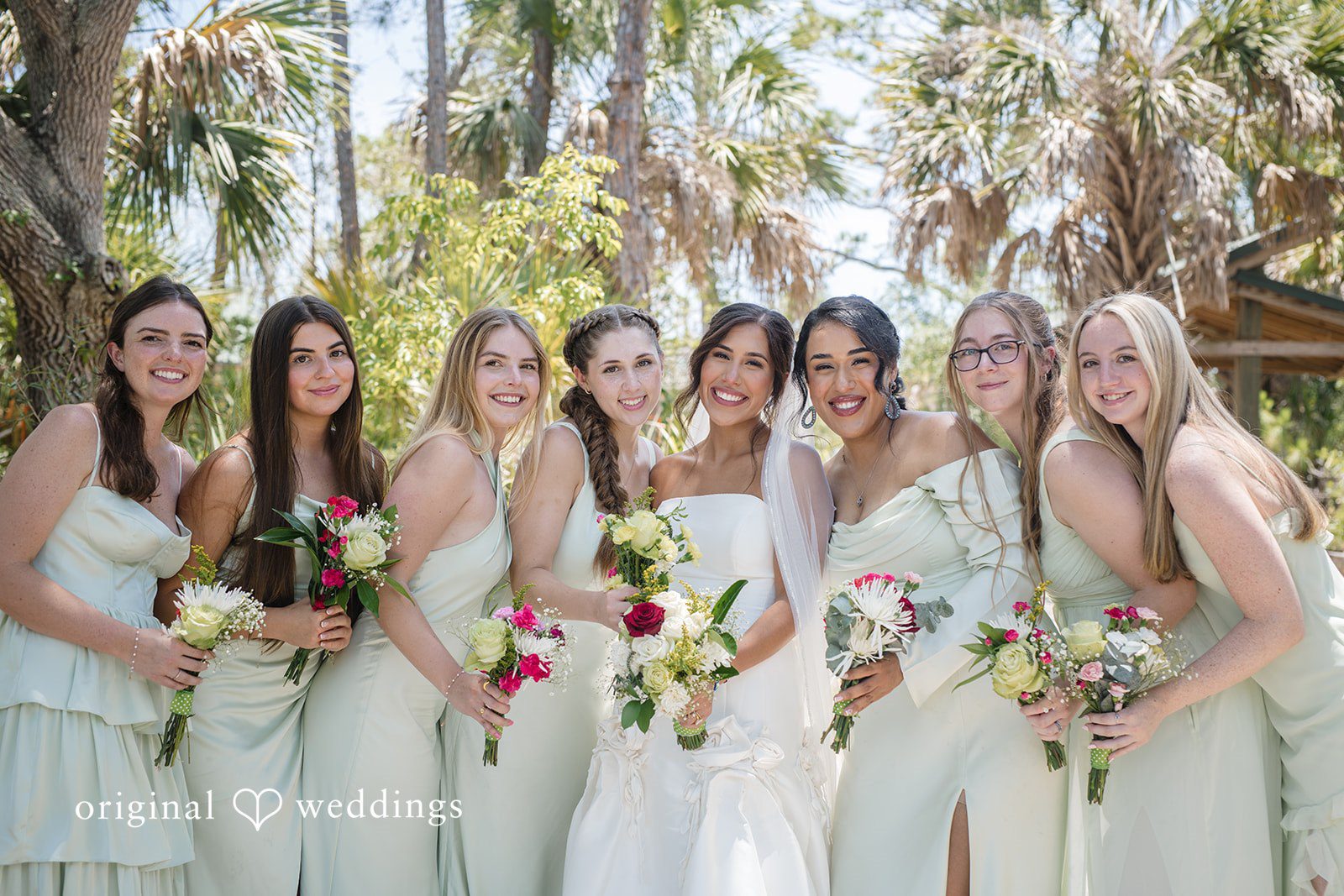 Bride posing with the bridesmaids before the ceremony at San Pedro Catholic Church
