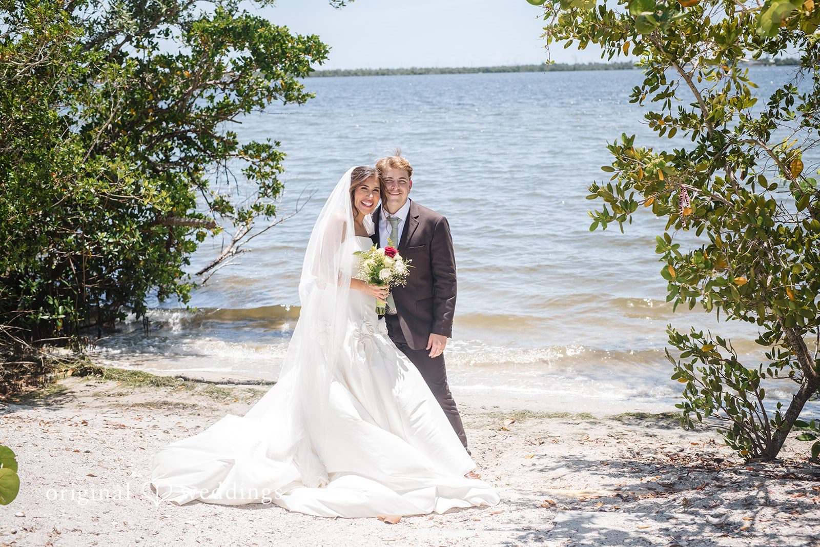 Tampa Wedding Photographers capturing romantic couple photoshoot while looking at the camera at San Pedro Catholic Church by Original Weddings