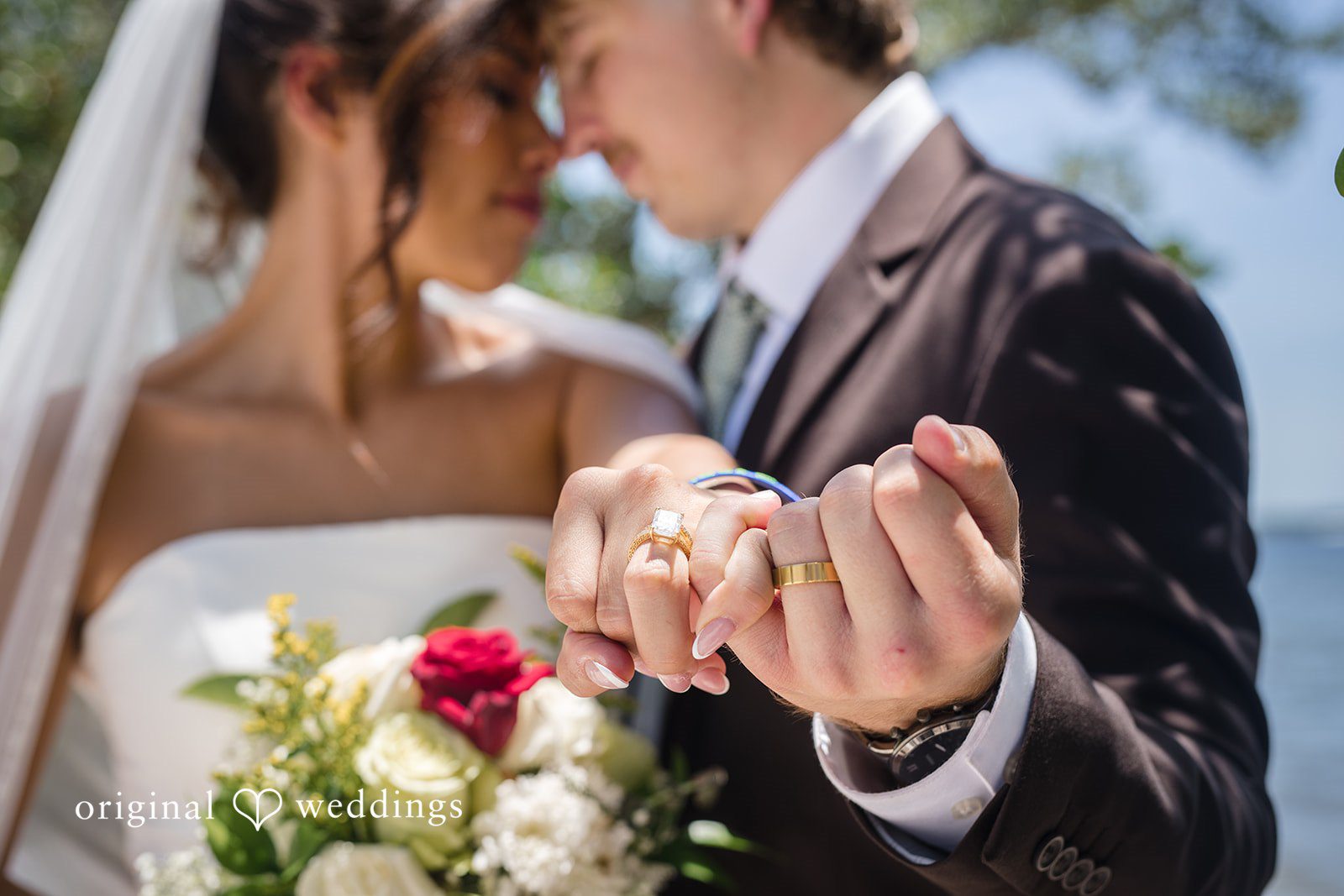 Couple showing their wedding rings in a close-up picture at San Pedro Catholic Church
