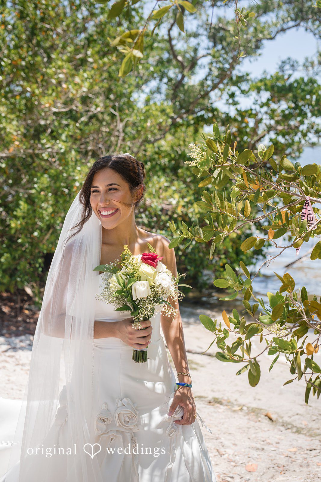 Bride smiling while holding a bouquet at San Pedro Catholic Church