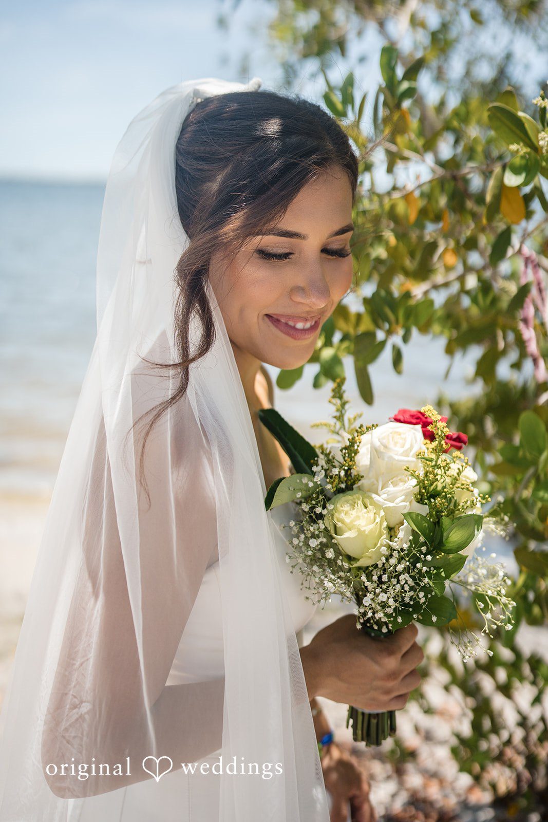 Bride posing with her bouquet at San Pedro Catholic Church