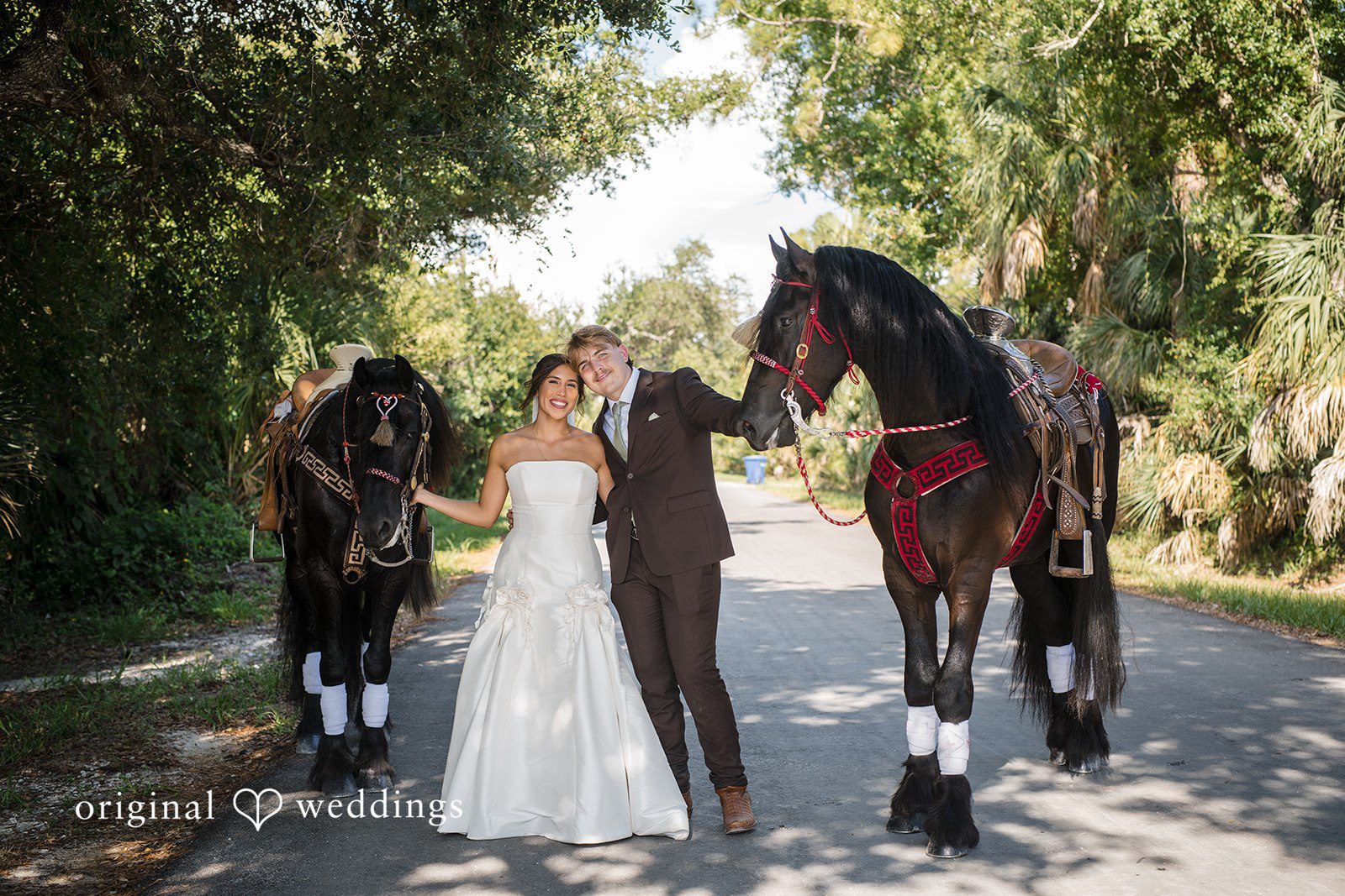 Tampa Wedding Photographers capturing couple smiling with the horses at San Pedro Catholic Church by Original Weddings