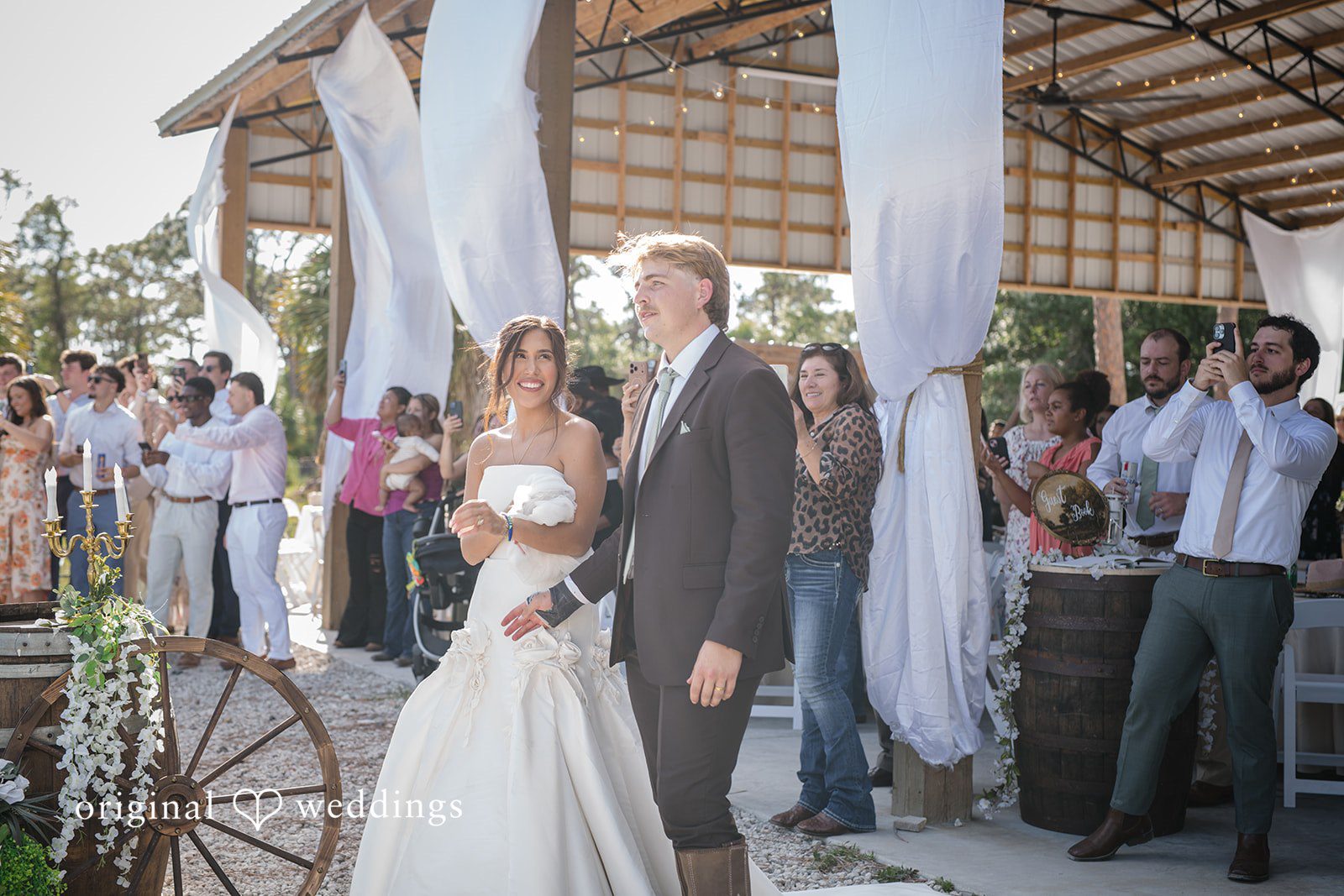 Couple smiling while walking outside at  San Pedro Catholic Church
