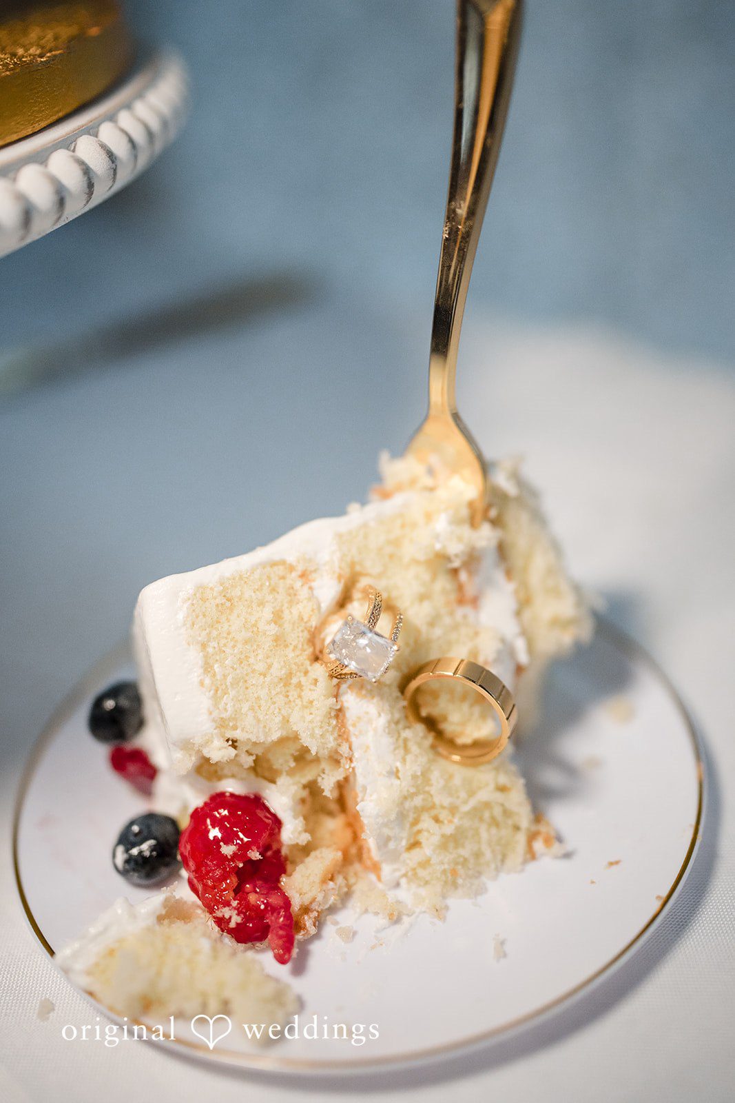 Close-up of a cake slice on a plate with the wedding rings at San Pedro Catholic Church
