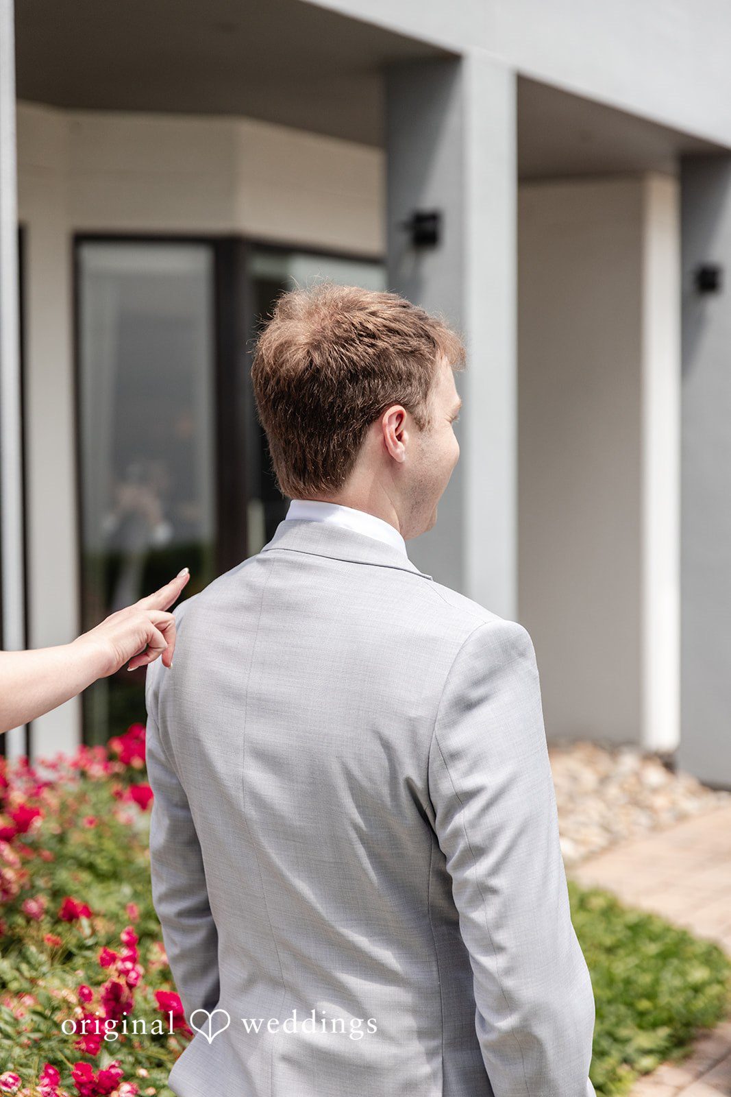 Bride placing her hand on the groom's shoulder during their portrait session at Terrain Garden