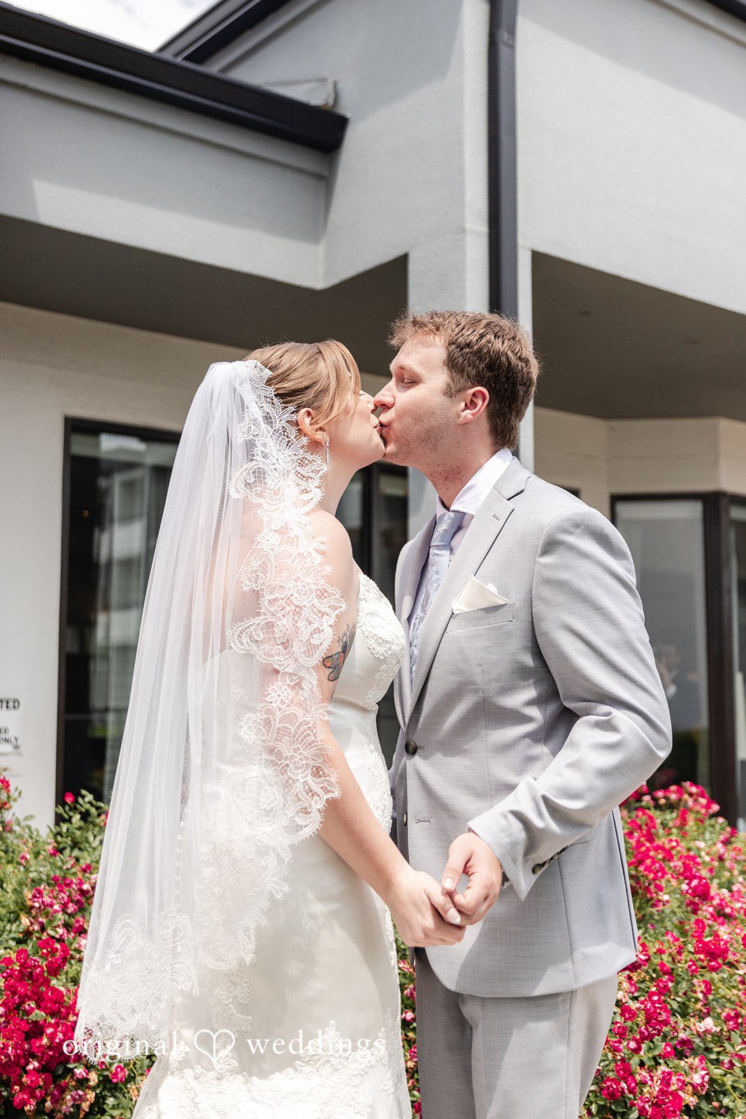 Bride and groom kissing during their portrait session at Terrain Garden