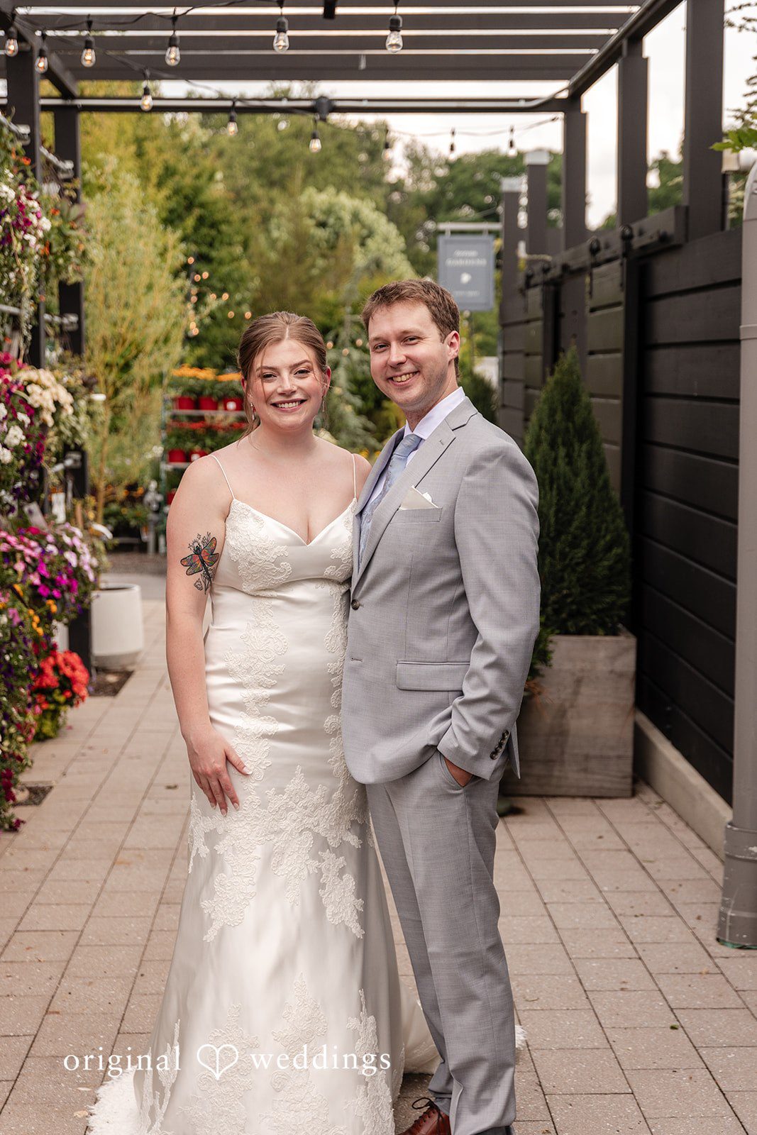 Bride and groom posing together while looking at the camera at Terrain Garden