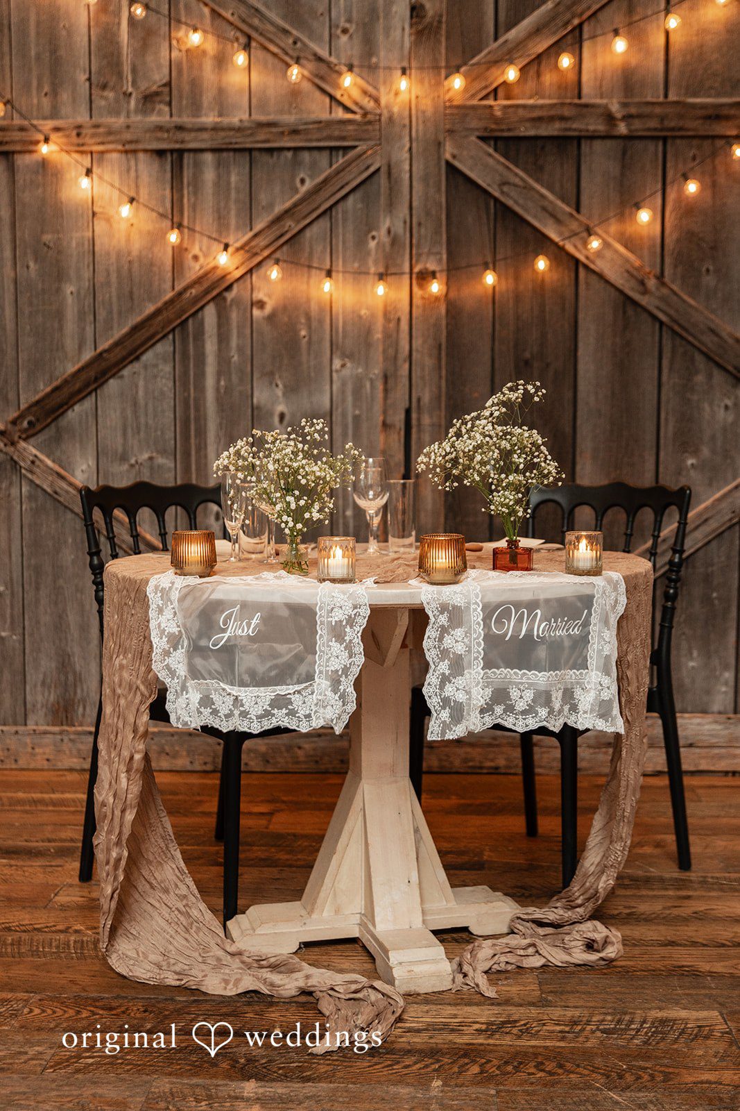 Center table decorated with flowers, candles, and glass décor at Terrain Garden