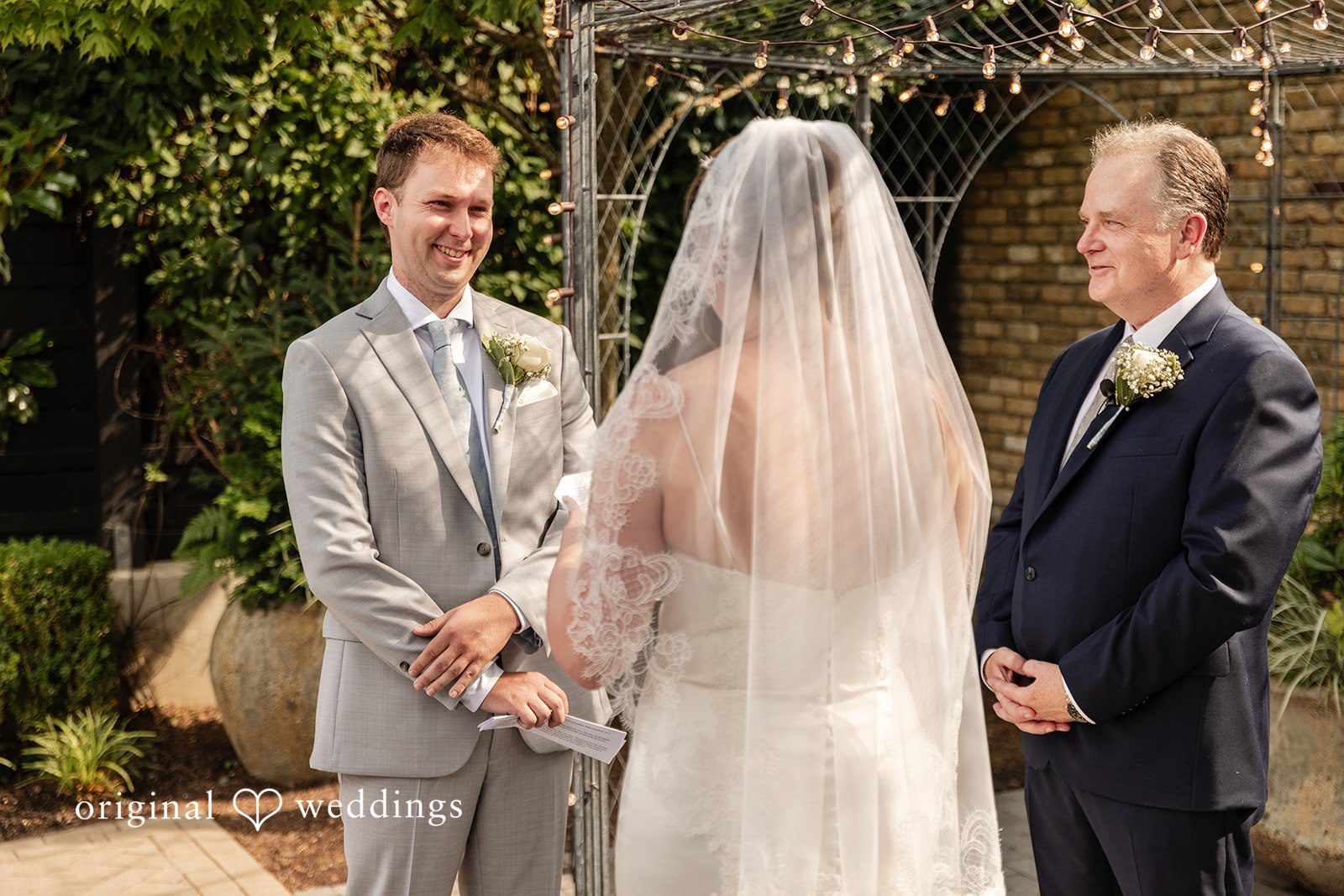 Bride and groom sharing eye contact during the ceremony at Terrain Garden
