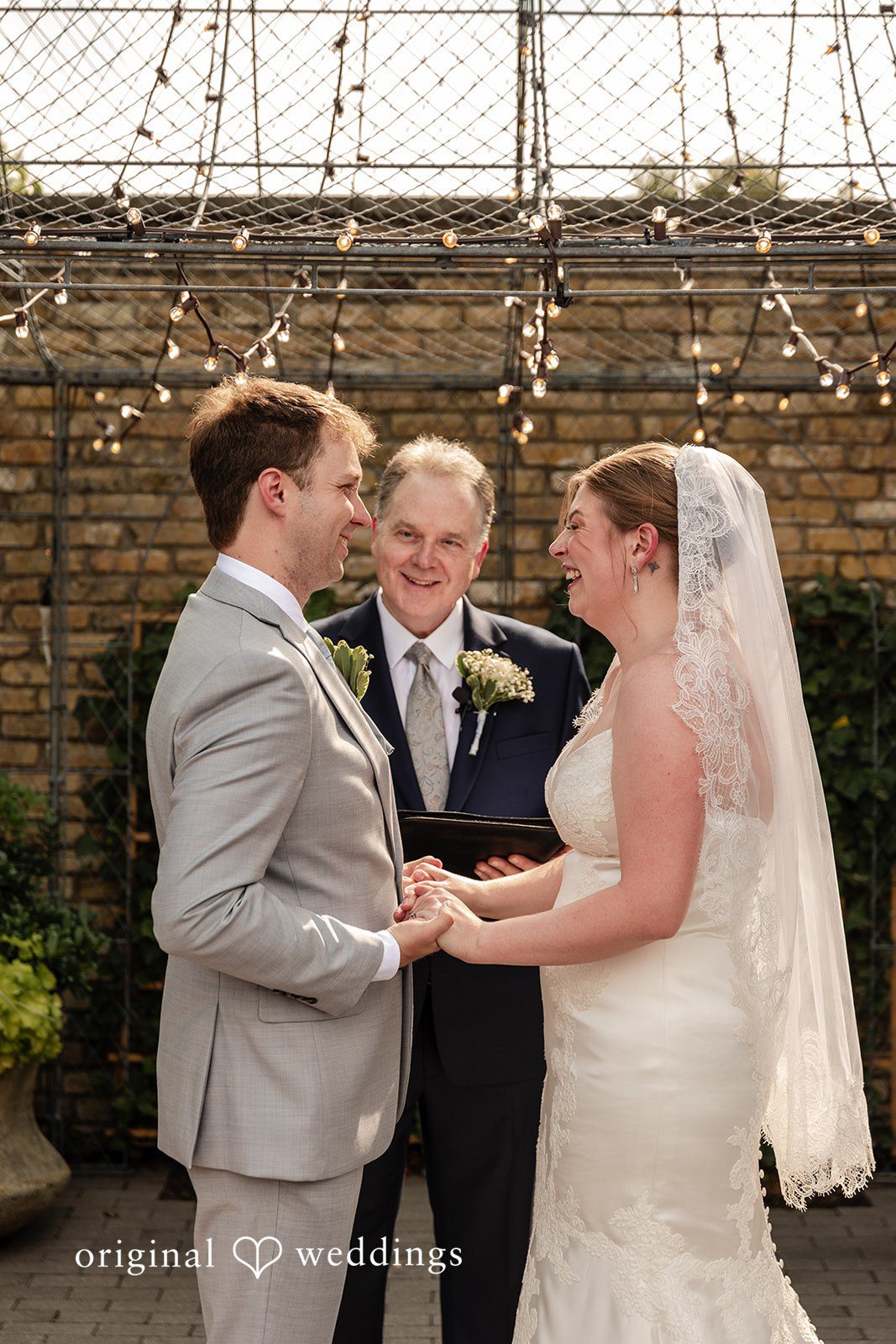 Philadelphia Wedding Photographers capturing couple holding hands and smiling at Terrain Garden by Original Weddings
