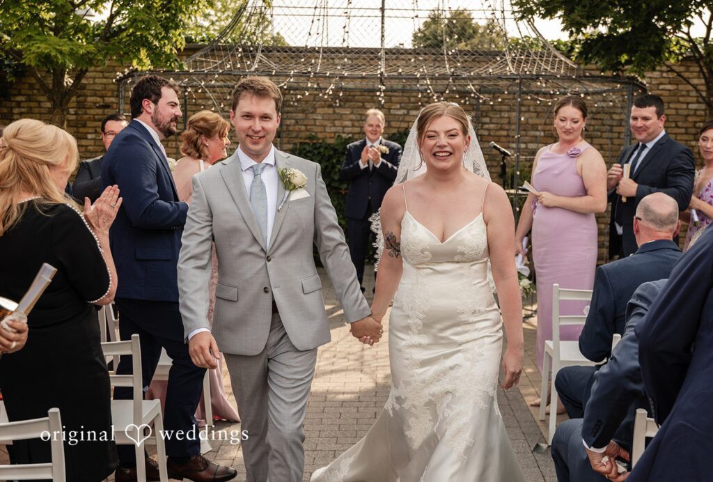 Philadelphia Wedding Photographers capturing groom and bride while leaving the altar smiling at Terrain Garden by Original Weddings