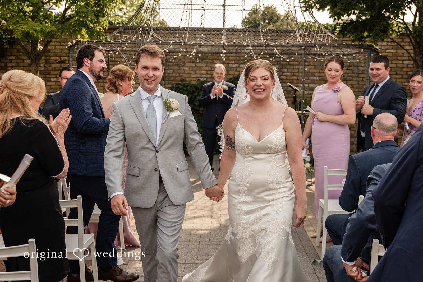 Philadelphia Wedding Photographers capturing couple walking outside after the ceremony at Terrain Garden by Original Weddings