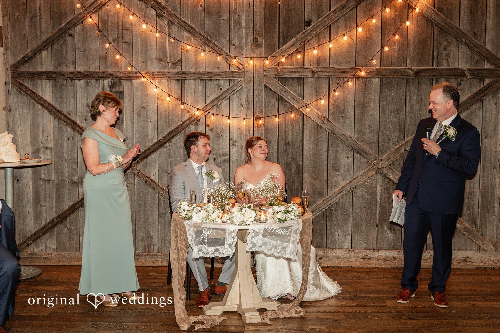 Philadelphia Wedding Photographers capturing couple sitting at the reception table at Terrain Garden by Original Weddings