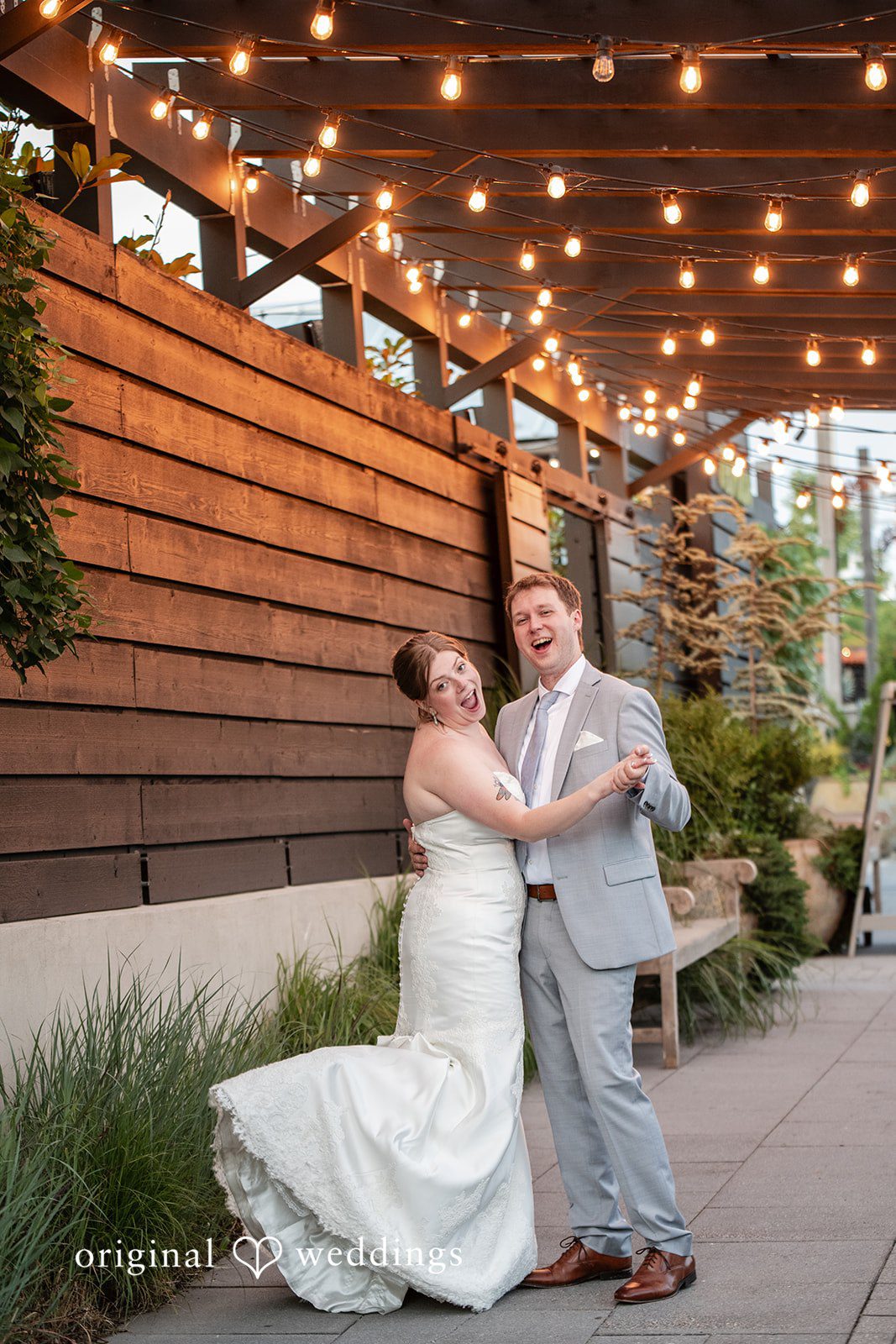 Couple smiling in a romantic dance pose at Terrain Garden