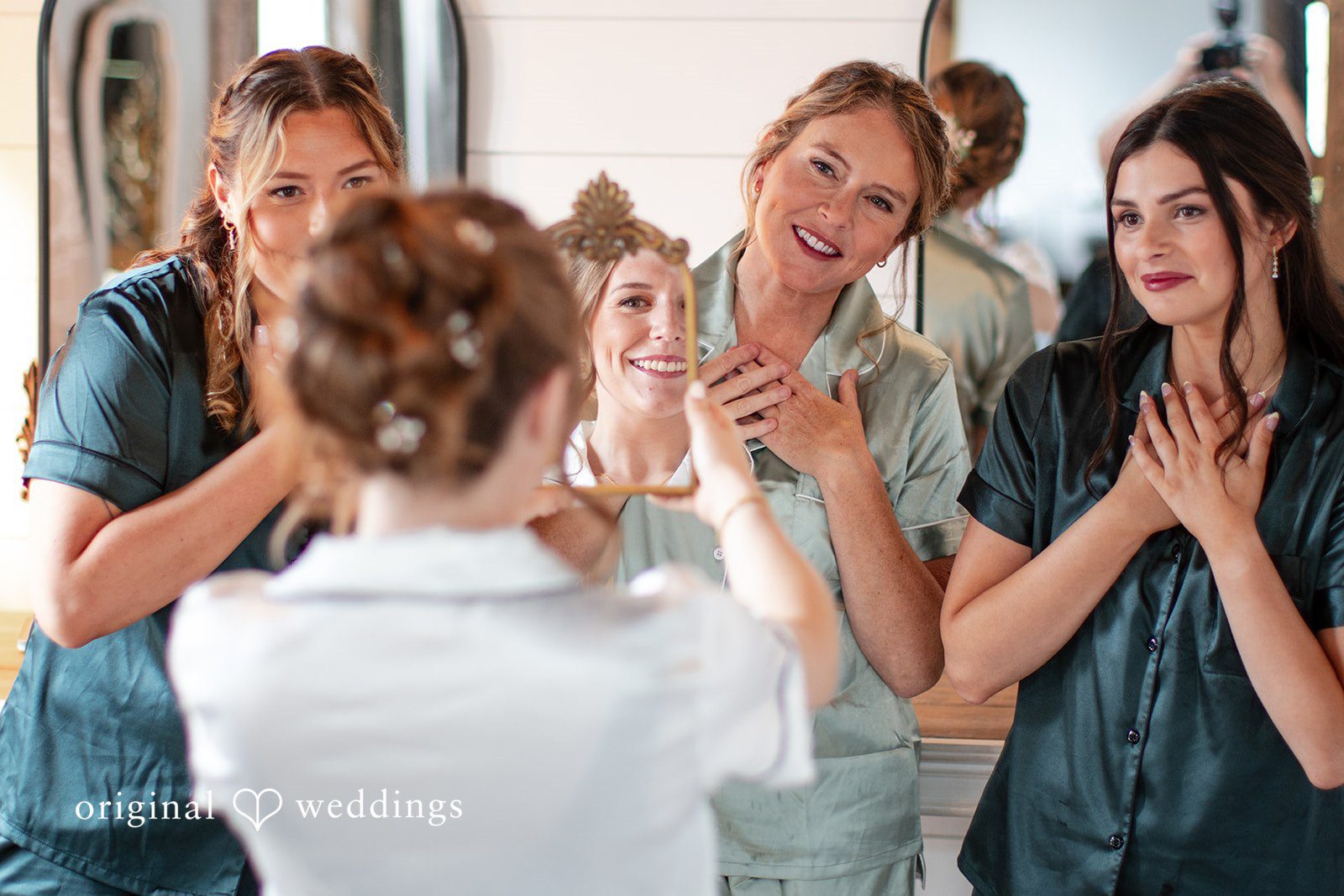 Madison + Ally Bridesmaids reacting with excitement as bride reveals her finished wedding look.