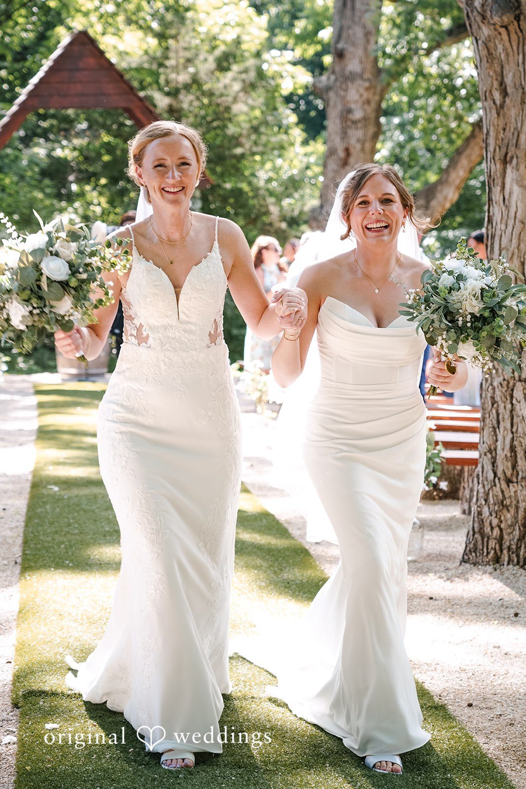 Madison + Ally Newly married couple smiling and holding bouquets after the ceremony.