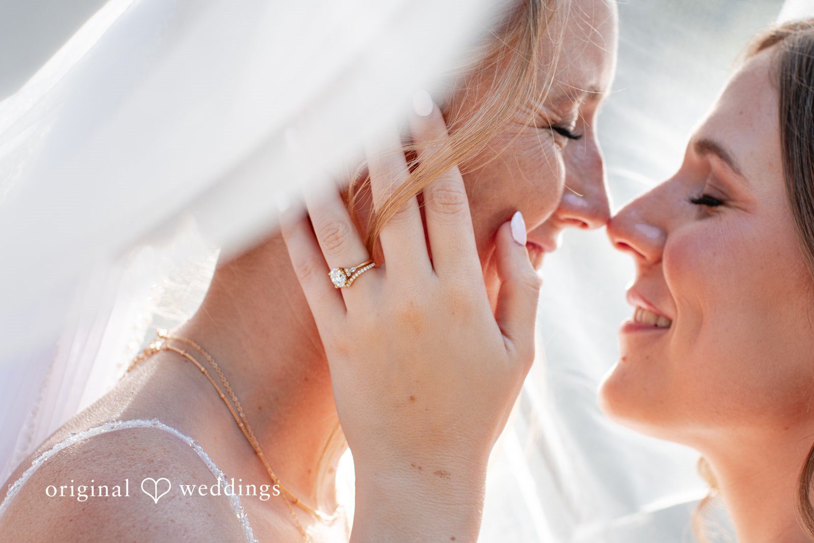 Madison + Ally Close-up wedding picture highlighting love, smiles, and wedding rings.