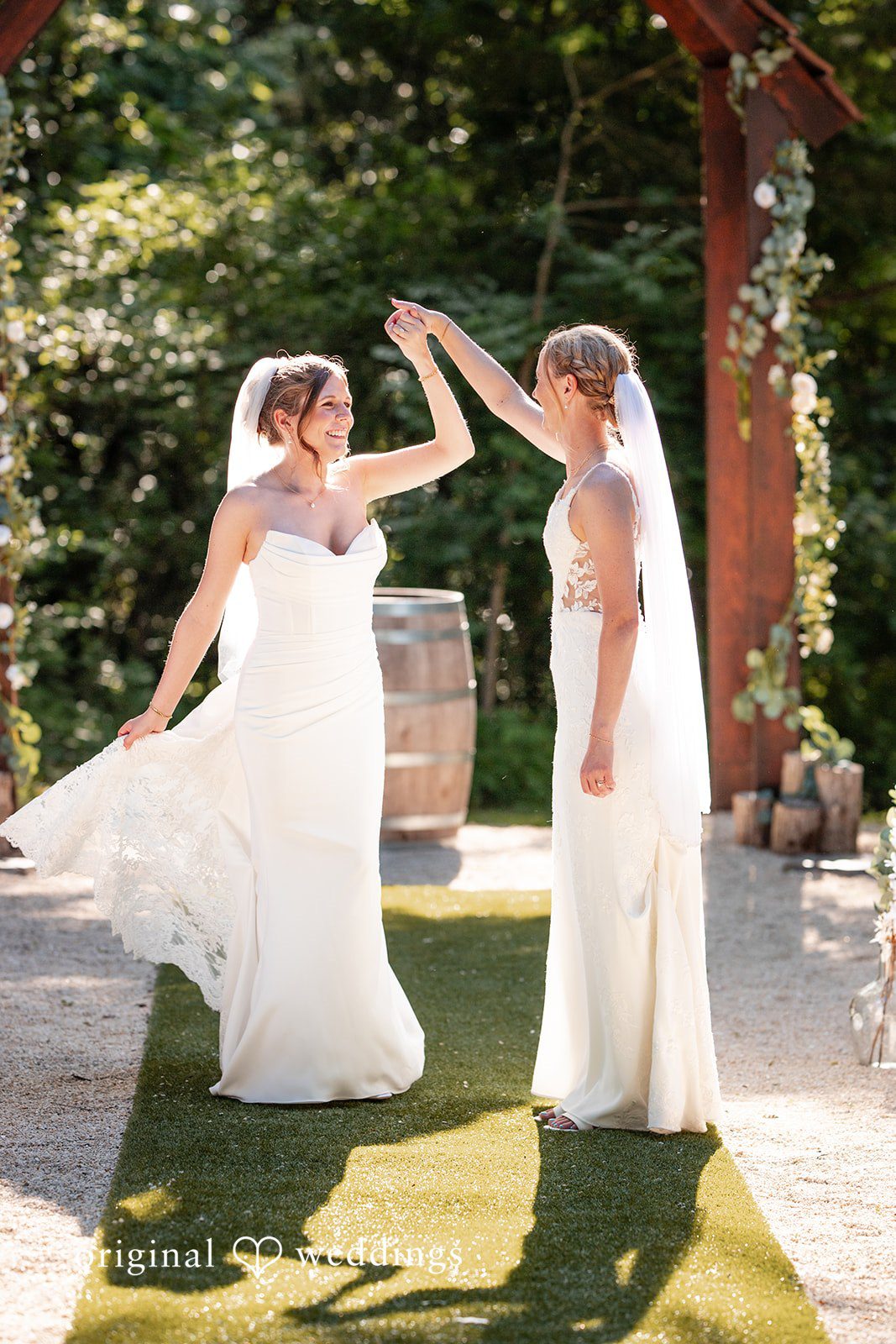 Madison + Ally Bride twirling her partner during a joyful wedding celebration.