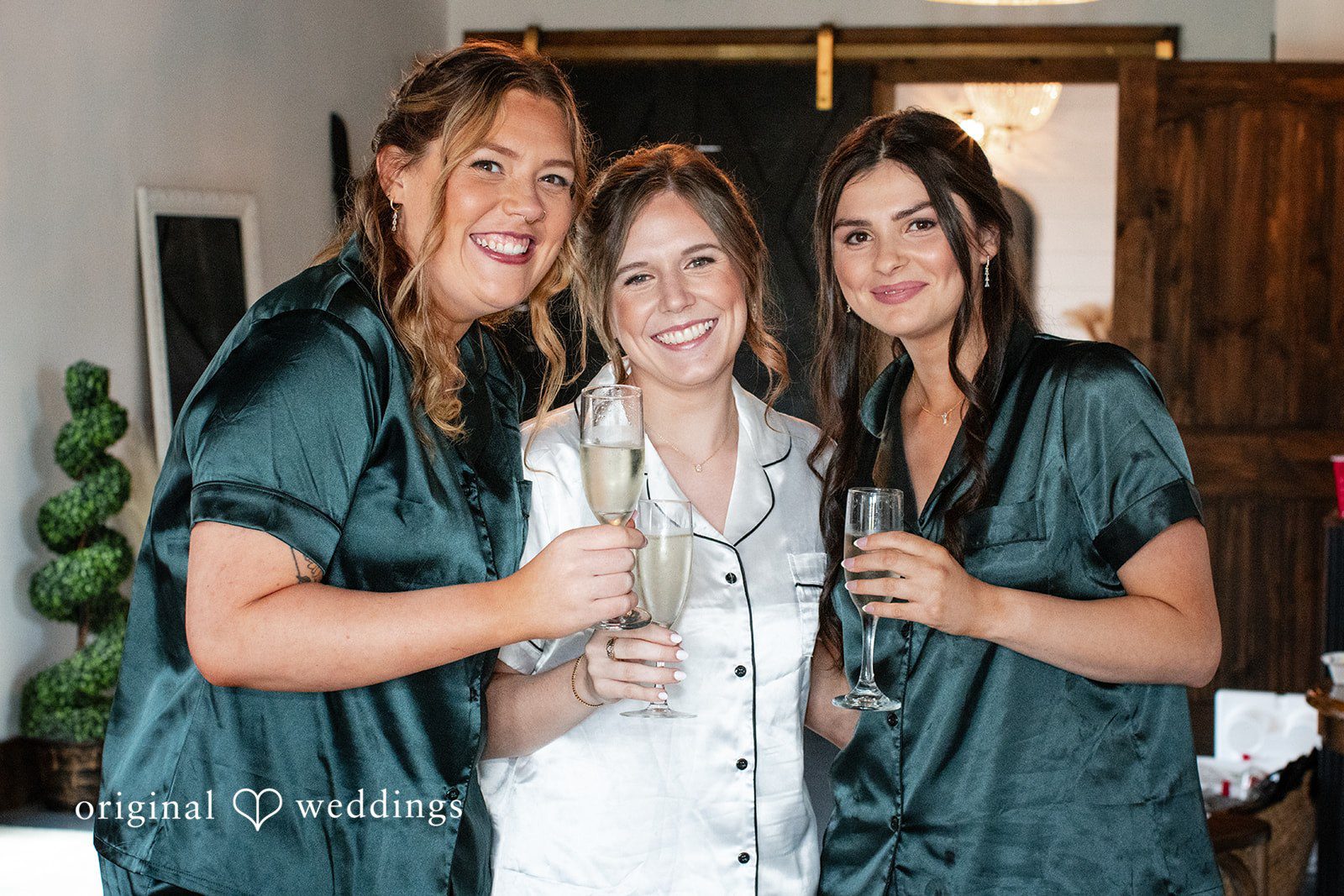 Madison + Ally Bride enjoying champagne with bridesmaids attendants while getting ready