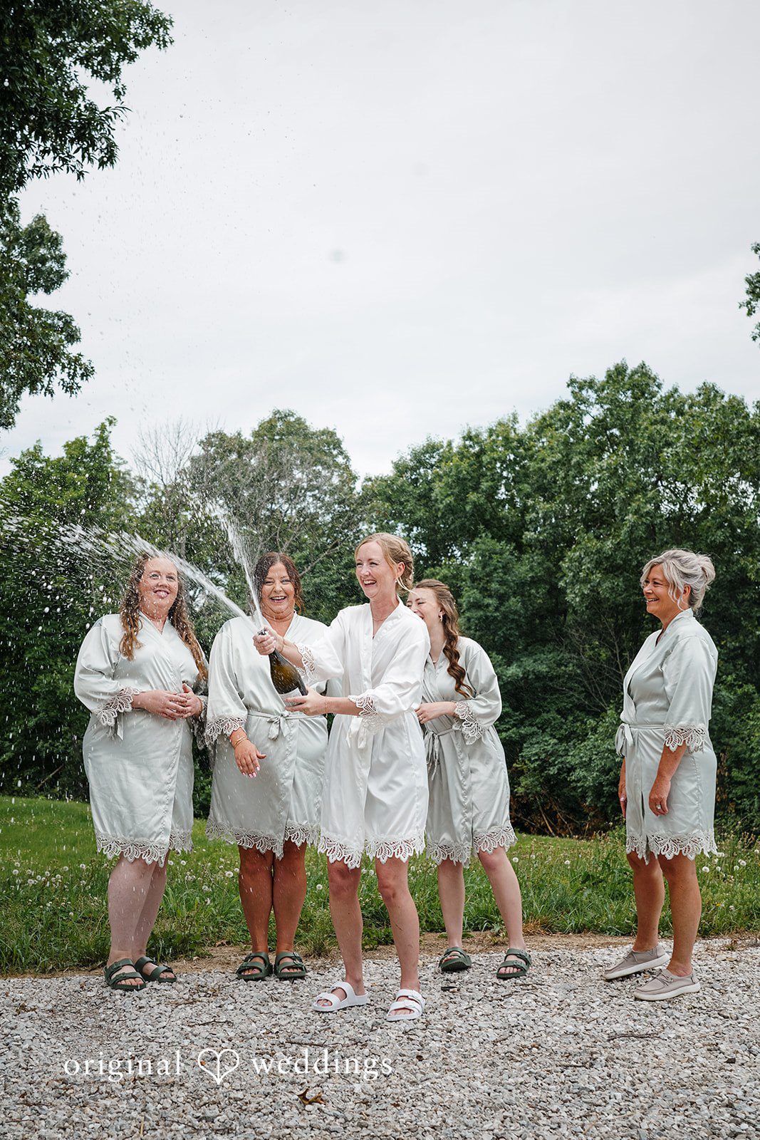 Madison + Ally Joyful pre-ceremony celebration with the bridemaidsoutdoors.