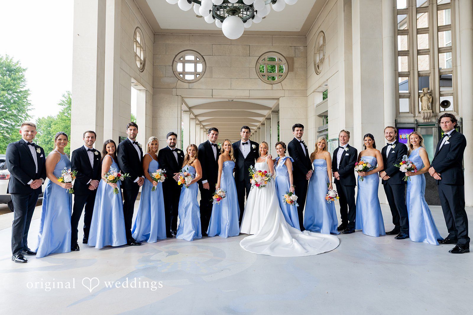 Our St. Louis wedding photographers at Original Weddings captured a stunning portrait of the couple and their bridal party at The Coronado