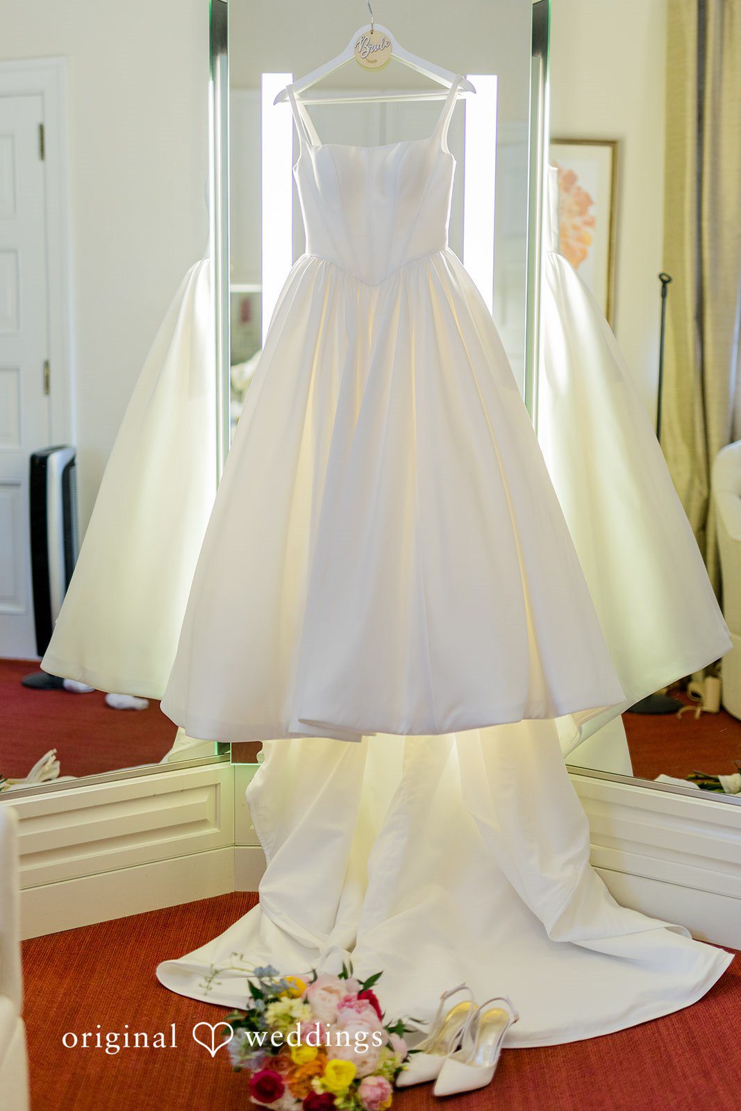 Maret + David The bride's gown gracefully hangs in the lodge