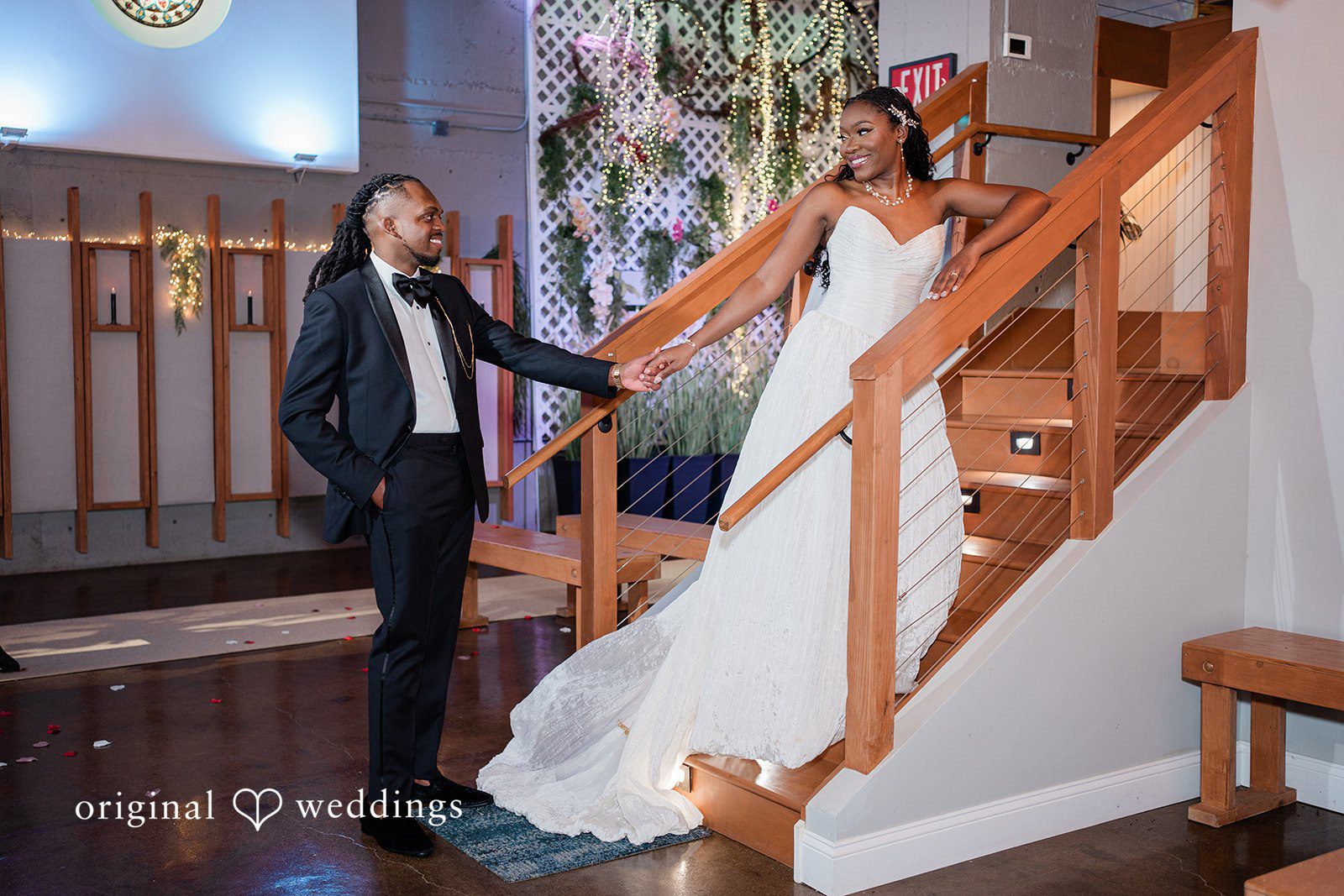 Khanyile + Shontel Bride and groom posing beside the venue staircase