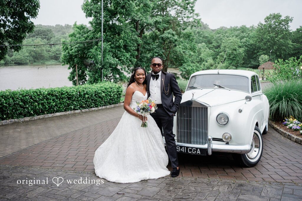 Khanyile + Shontel Bride and groom posing in front of their wedding car